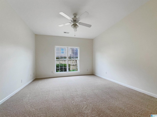 carpeted spare room with ceiling fan