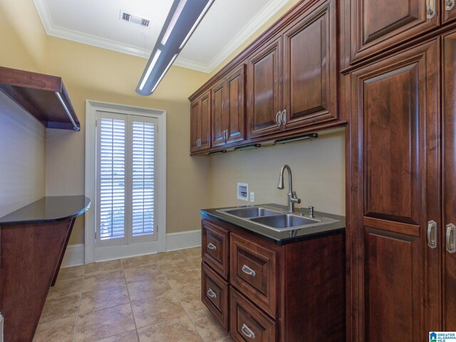 kitchen with sink, light tile flooring, and crown molding