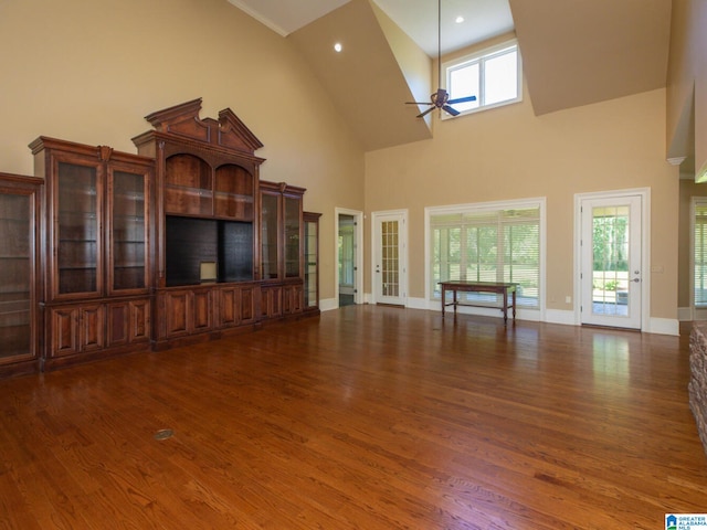 unfurnished living room with high vaulted ceiling, ceiling fan, and dark hardwood / wood-style floors