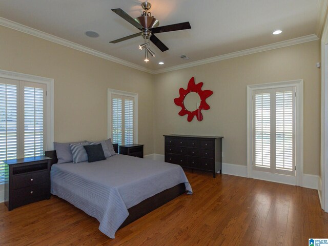 bedroom featuring wood-type flooring, ornamental molding, and ceiling fan