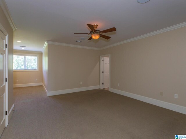 carpeted spare room with ceiling fan and ornamental molding