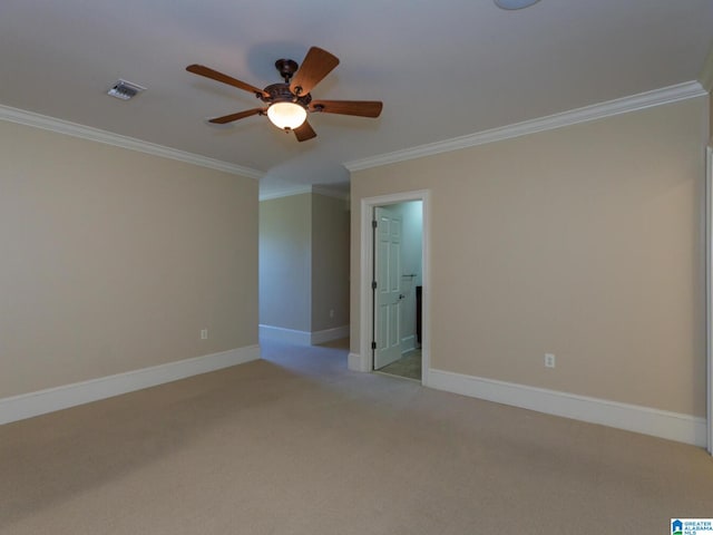 carpeted spare room with ornamental molding and ceiling fan