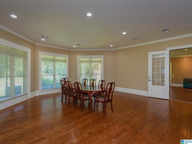 dining room featuring hardwood / wood-style floors and ornamental molding