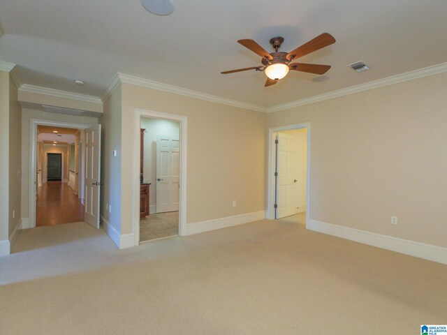 empty room with crown molding, carpet floors, and ceiling fan