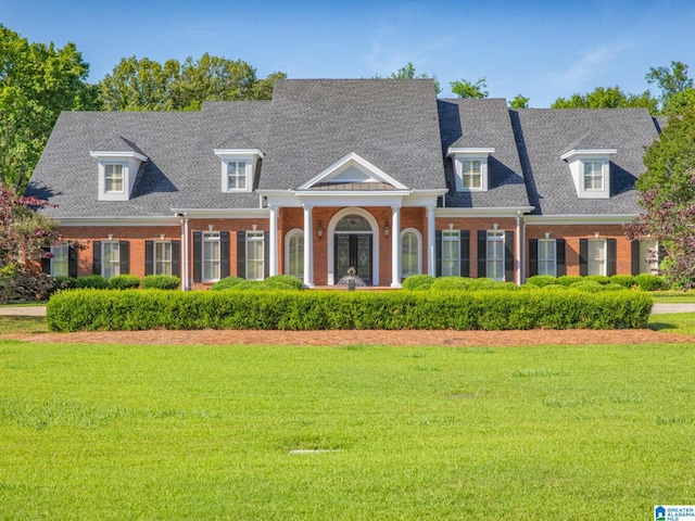 new england style home featuring a front lawn