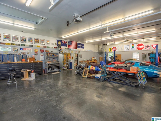 garage with a workshop area and a garage door opener