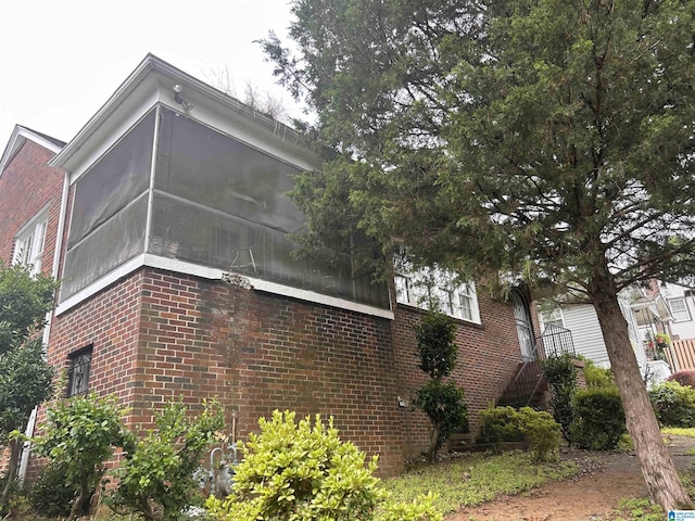 view of property exterior featuring a sunroom