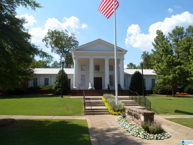 greek revival inspired property with a front yard