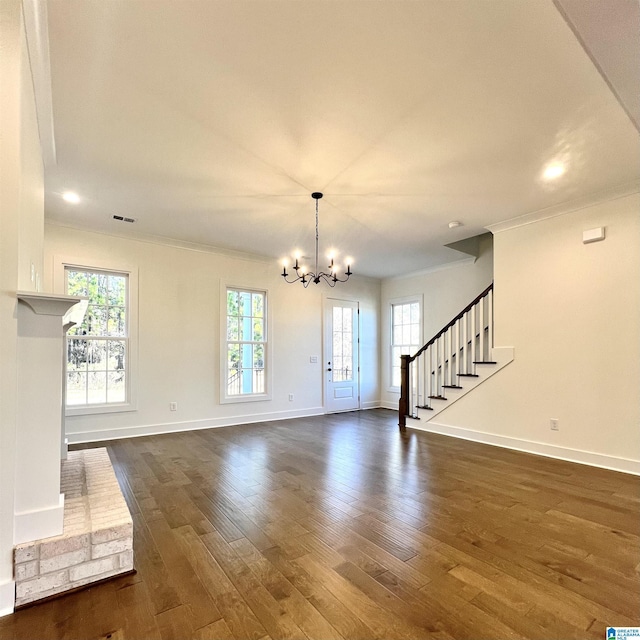 interior space featuring crown molding, dark hardwood / wood-style flooring, and a notable chandelier