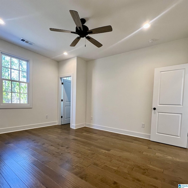 spare room with ceiling fan and dark hardwood / wood-style flooring