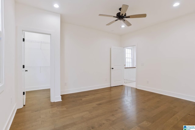 spare room featuring hardwood / wood-style floors and ceiling fan