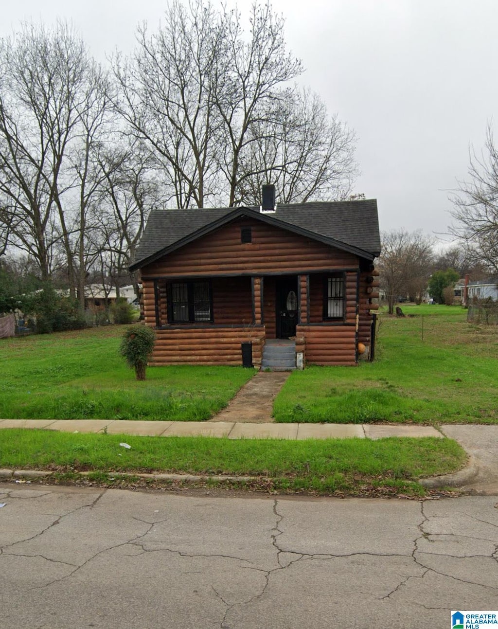 log-style house with a front yard