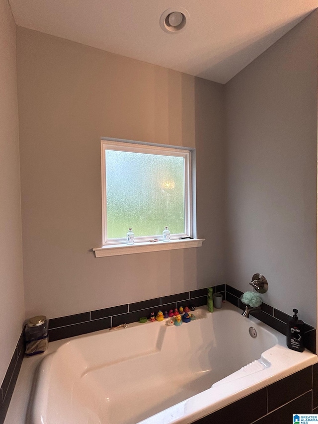 bathroom with tiled tub