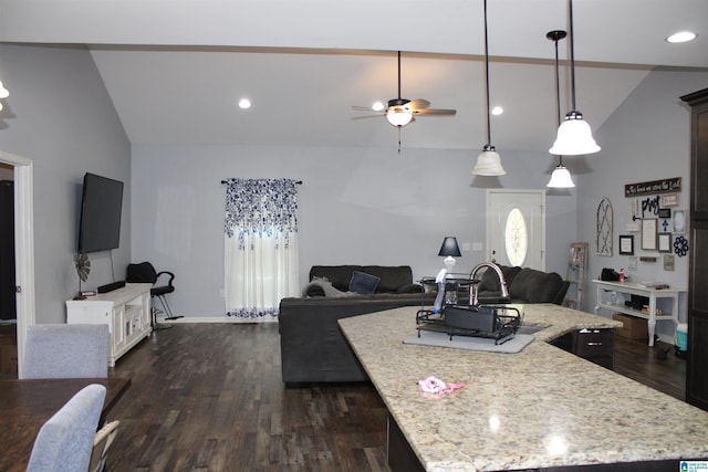 kitchen with dark wood finished floors, open floor plan, an island with sink, and a sink