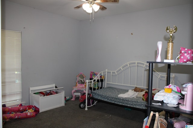 bedroom featuring ceiling fan and carpet