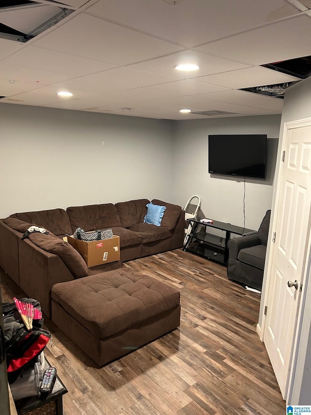 living room featuring recessed lighting, a drop ceiling, and wood finished floors