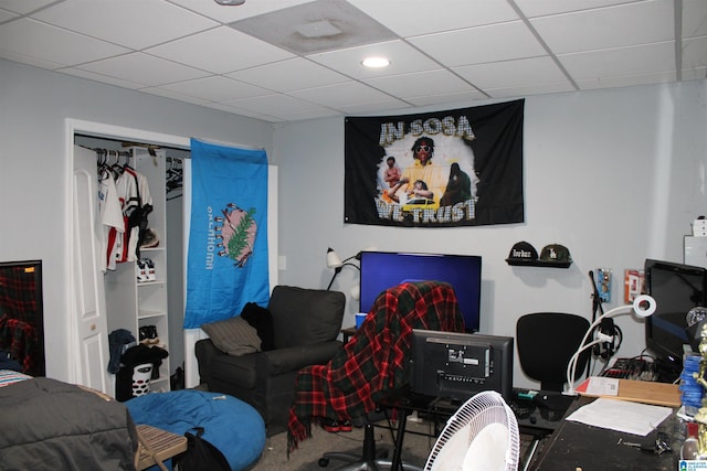 playroom featuring a paneled ceiling and carpet floors