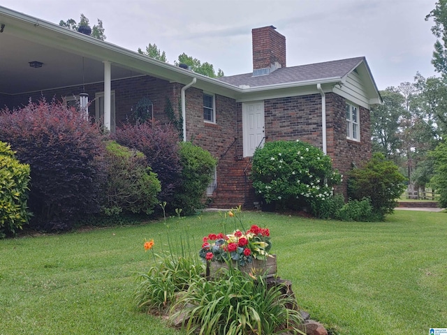 view of side of home featuring a lawn