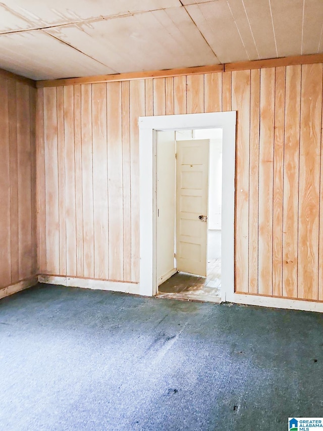 spare room with wood walls