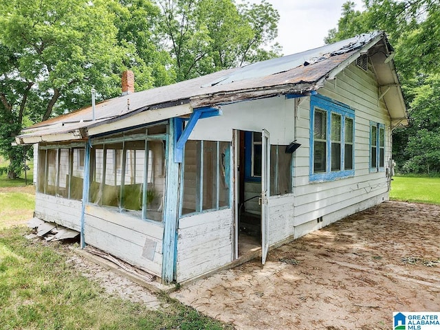 view of side of property featuring a sunroom