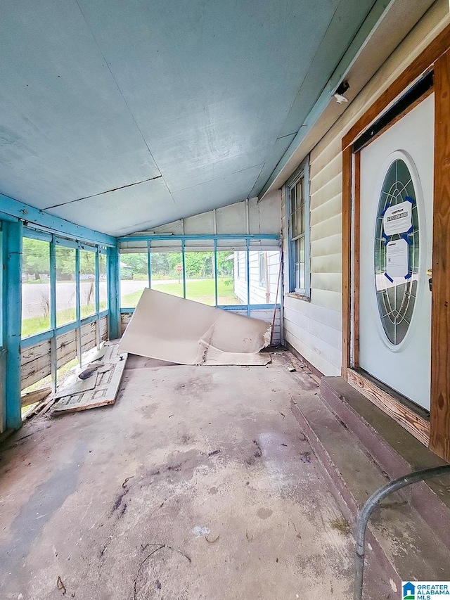 unfurnished sunroom featuring lofted ceiling