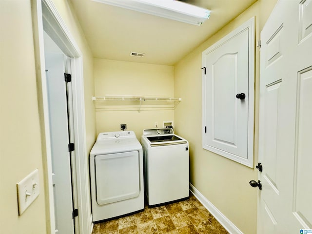 washroom featuring washer and dryer, hookup for an electric dryer, light tile floors, and washer hookup