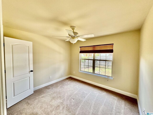 carpeted empty room with ceiling fan