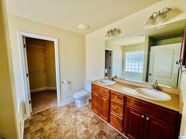 bathroom featuring dual bowl vanity, tile flooring, and toilet