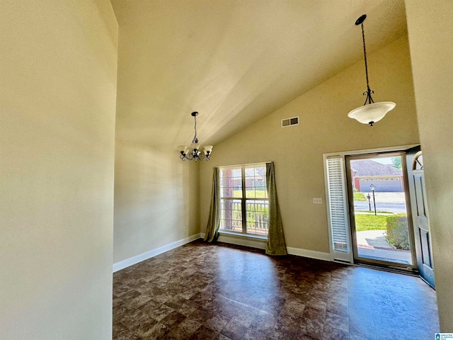 tiled foyer with high vaulted ceiling and a notable chandelier