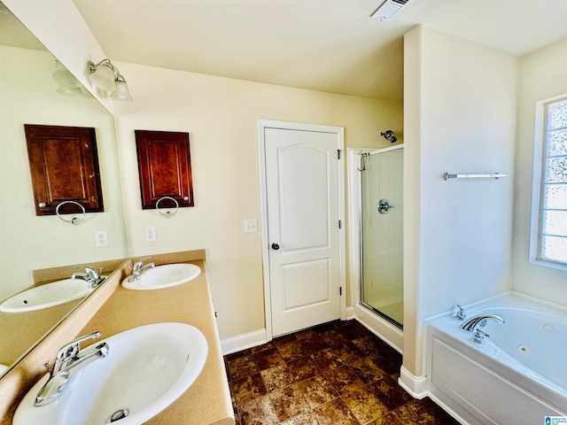 bathroom featuring a wealth of natural light, double sink, shower with separate bathtub, and vanity with extensive cabinet space