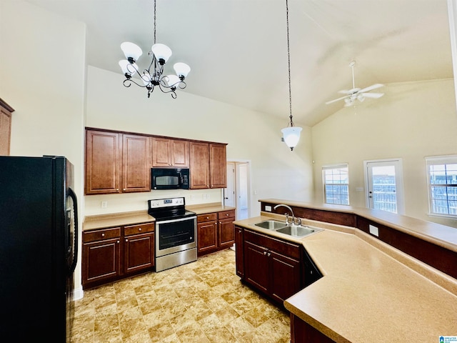 kitchen featuring sink, decorative light fixtures, black appliances, and light tile floors