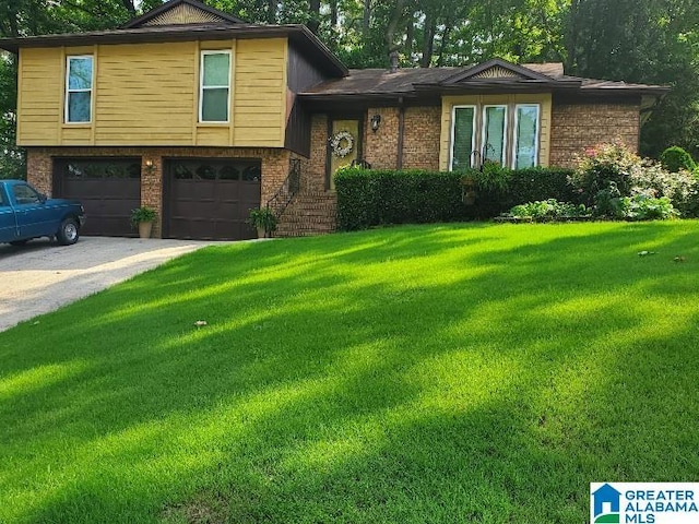 split level home with a front yard and a garage