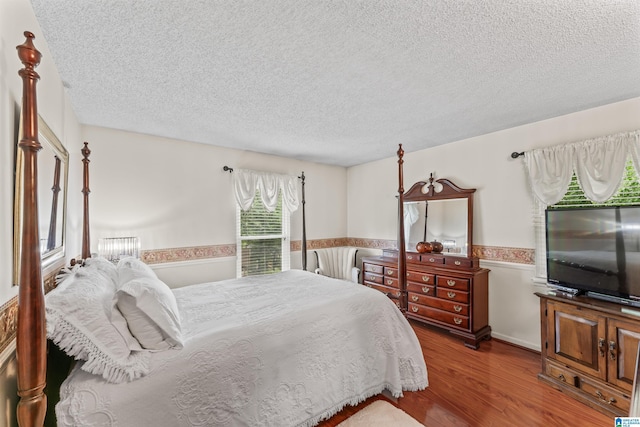 bedroom featuring a textured ceiling and wood-type flooring