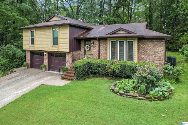 split level home featuring central air condition unit, a garage, and a front lawn