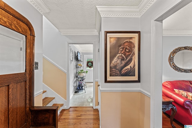 foyer featuring light wood-type flooring and a textured ceiling