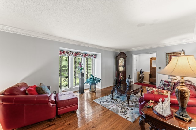 living room featuring hardwood / wood-style flooring, a textured ceiling, and ornamental molding