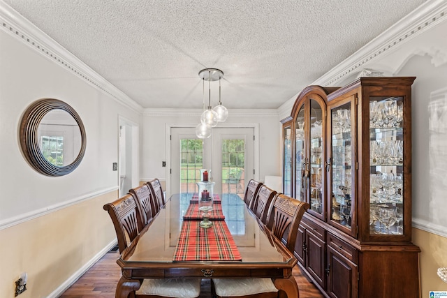 dining area with crown molding, a textured ceiling, and dark hardwood / wood-style floors