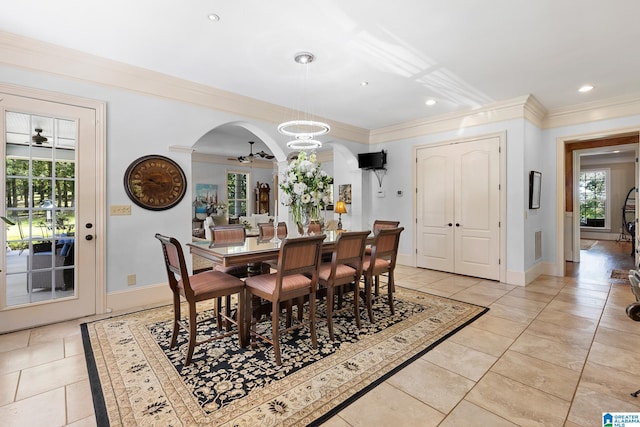 tiled dining area with crown molding, plenty of natural light, and ceiling fan