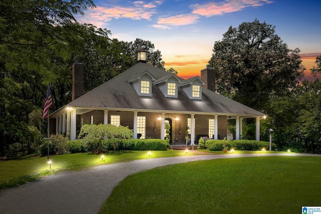 new england style home with a lawn