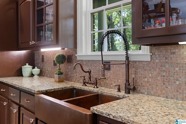 kitchen with dark brown cabinets and backsplash