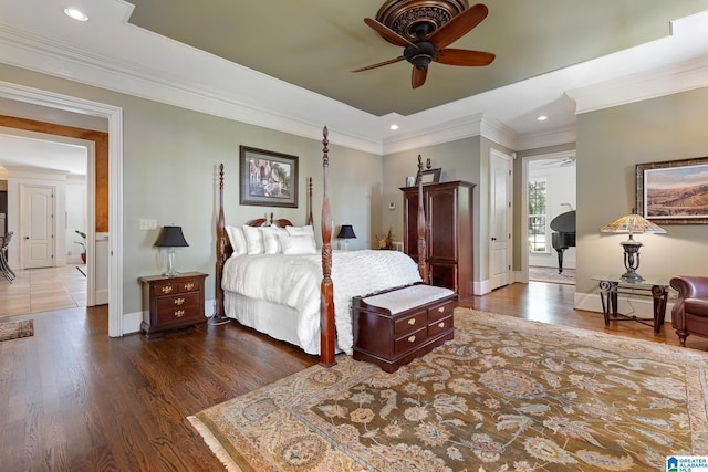 bedroom featuring crown molding, dark hardwood / wood-style floors, and ceiling fan