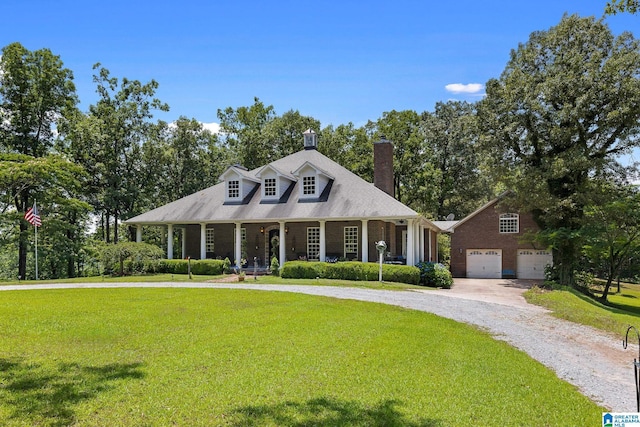 cape cod house with a garage, covered porch, and a front yard