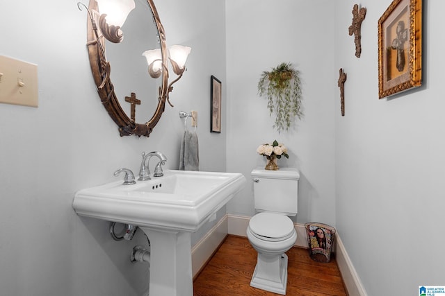 bathroom featuring hardwood / wood-style flooring and toilet