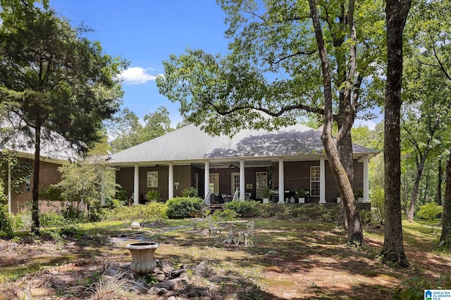 view of front of house with ceiling fan and a porch