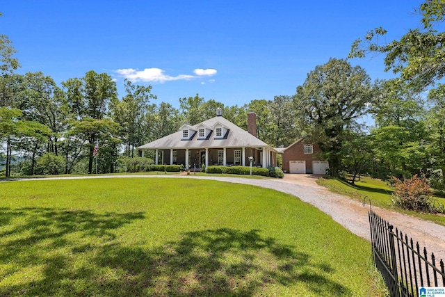 view of front facade with a porch, a garage, and a front yard