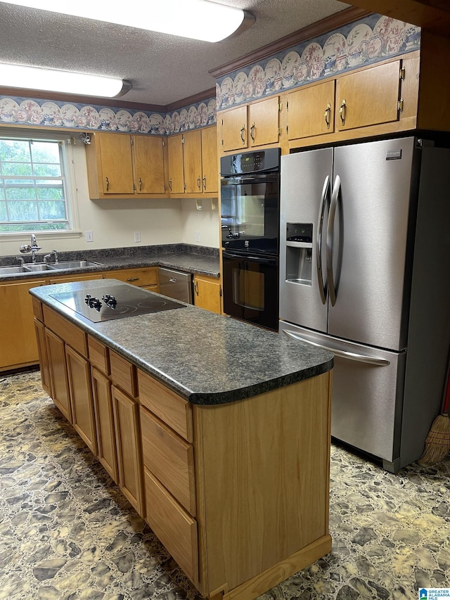 kitchen with sink, black appliances, and a textured ceiling