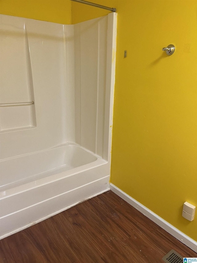 bathroom with shower / bathing tub combination and wood-type flooring