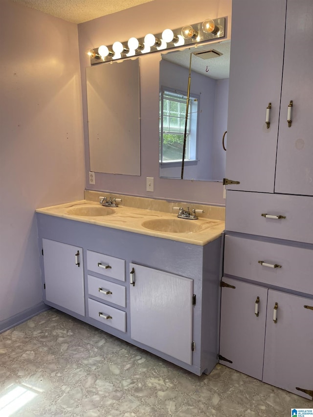 bathroom featuring vanity and a textured ceiling