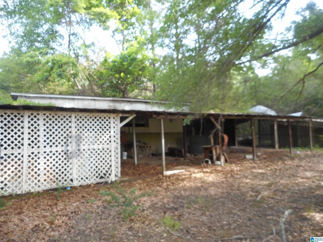 rear view of property with an outbuilding