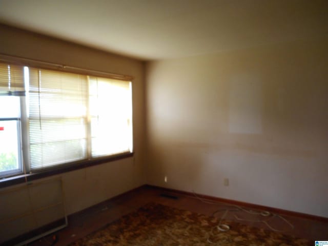 spare room with visible vents and baseboards